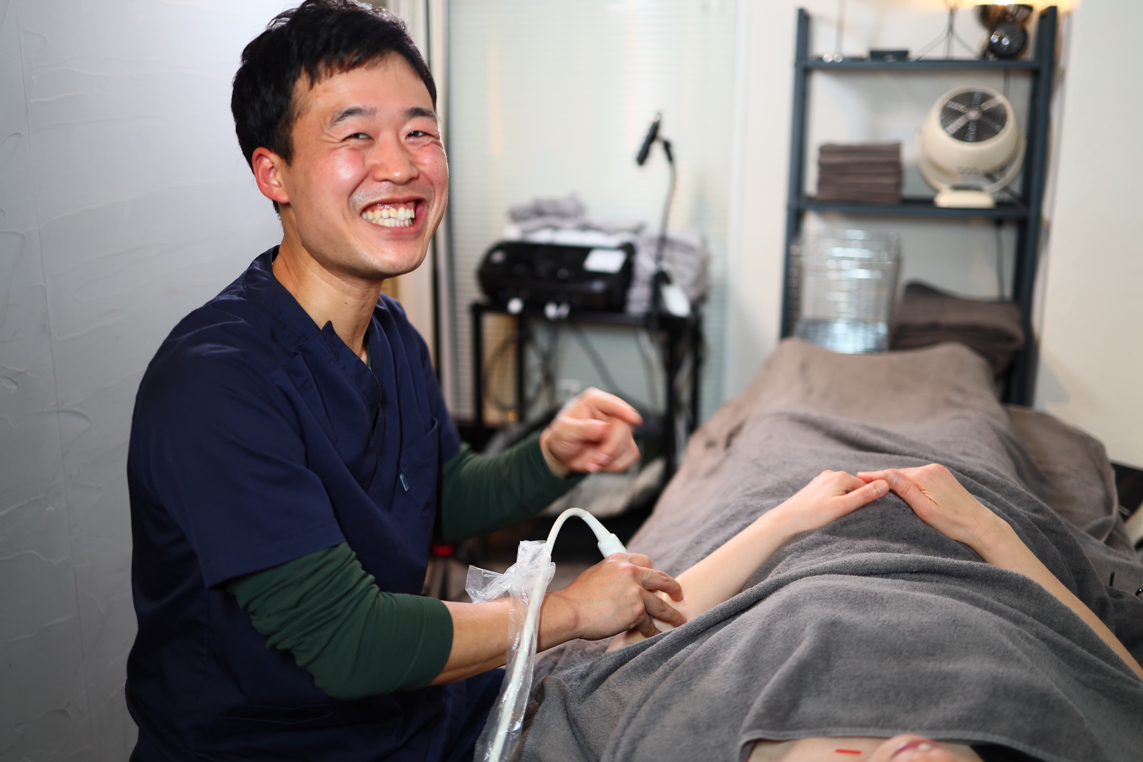 Soichiro Funo using ultrasound imaging during a clinical assessment
